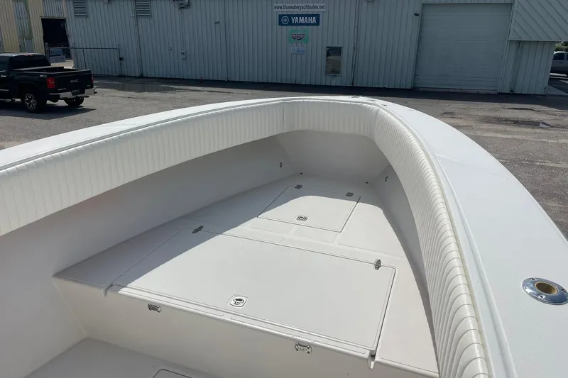 Slide: The Image of 2003 Jupiter 27 boat with spacious deck and white cushioned seating. - 28