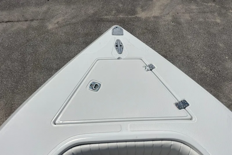 Slide: The Image of Bow of a 2003 Jupiter 27 boat with storage compartment and cleat. - 30