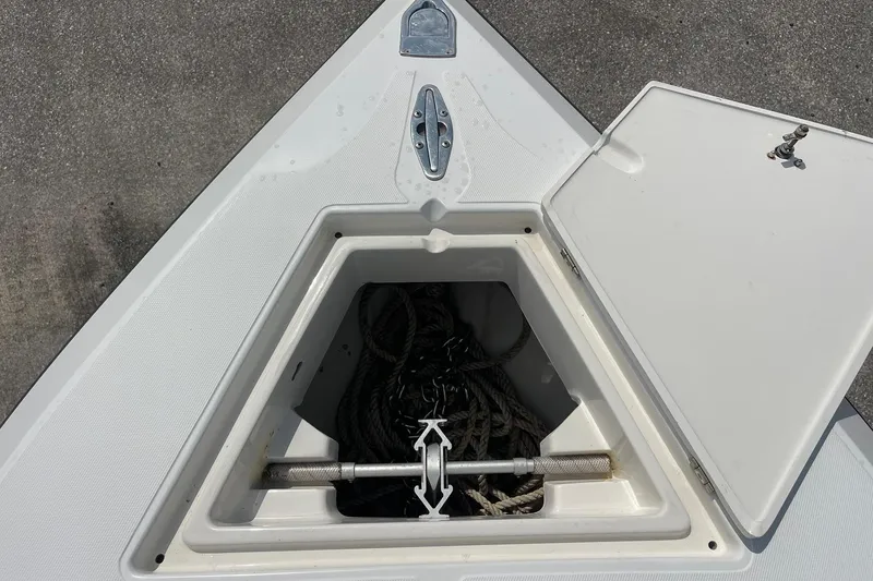 Slide: The Image of Open anchor locker on 2003 Jupiter 27 boat, showing ropes and hardware. - 31