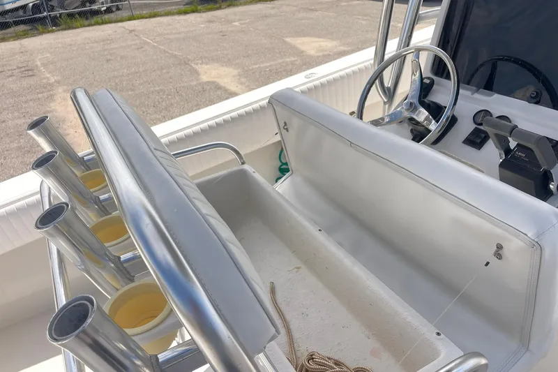 Slide: The Image of 2003 Jupiter 27 boat with dual outboard motors and white seating. - 42