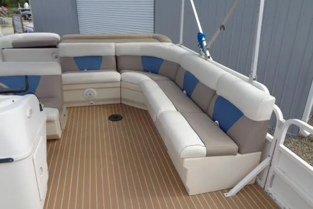Slide: The Image of 2008 Bentley Pontoons 200 CRUISE interior with beige and blue seating on a wooden deck. - 11