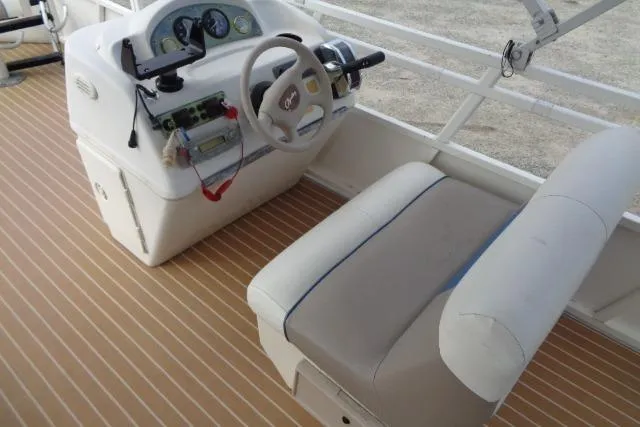 Slide: The Image of 2008 Bentley Pontoons 200 CRUISE helm with steering wheel and controls on a wooden deck. - 13