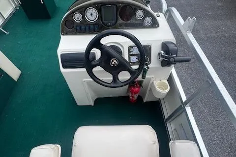 Slide: The Image of 2005 Tahoe Fish-N-Fun 22 boat dashboard with steering wheel and controls. - 12