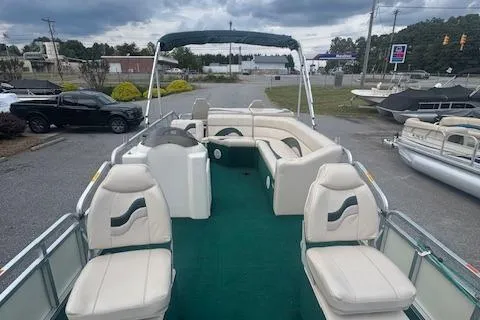 Slide: The Image of 2005 Tahoe Fish-N-Fun 22 pontoon boat with green carpet and white seating. - 7