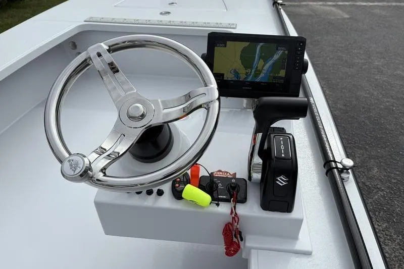 Slide: The Image of 2025 East Cape EVO boat console with steering wheel, GPS display, and controls. - 10