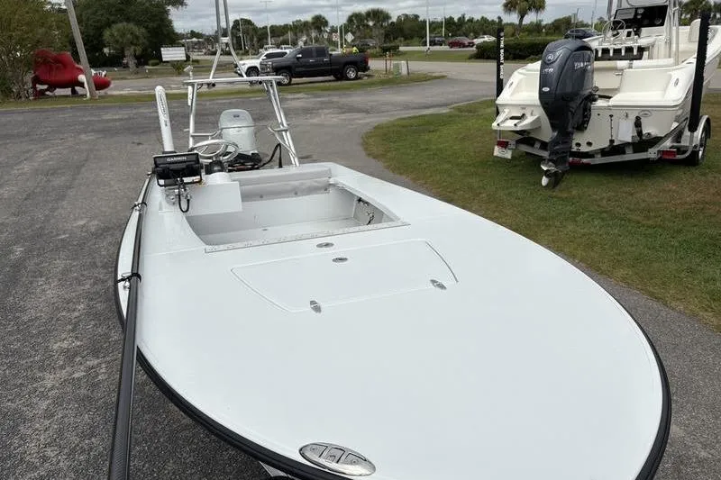 Slide: The Image of 2025 East Cape EVO boat parked outdoors, showcasing sleek design and modern features. - 14