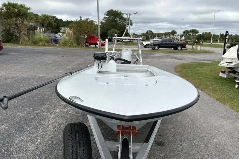 Slide: The Image of 2025 East Cape EVO boat on trailer in parking lot, overcast sky. - 6