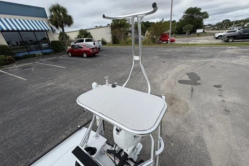 Slide: The Image of 2025 East Cape EVO boat with elevated platform in a parking lot. - 8