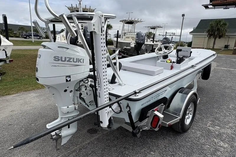 Slide: The Image of 2025 East Cape EVO boat with Suzuki engine on a trailer, parked outdoors. - 3