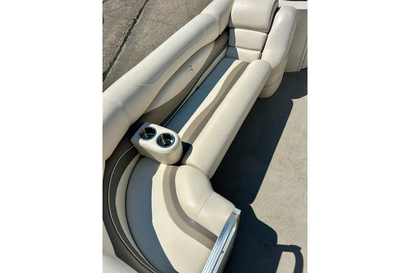 Slide: The Image of 2006 Bennington 2250 RL boat interior with beige seating and cup holders. - 13