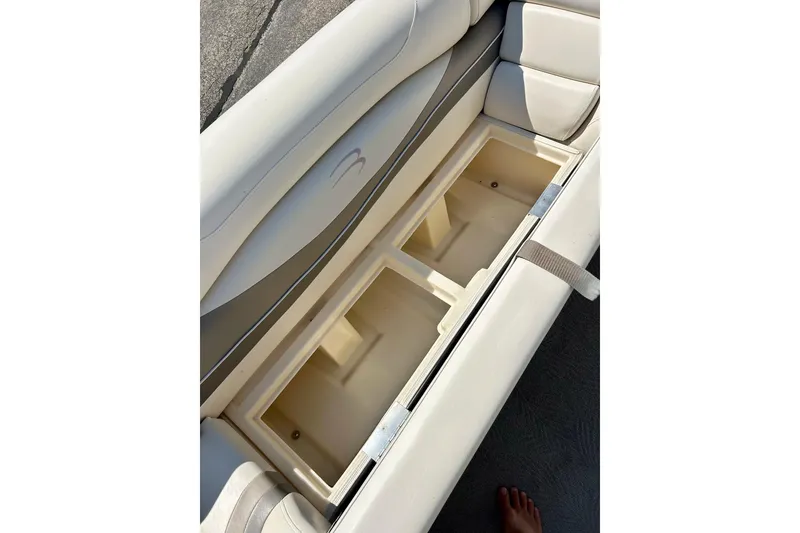 Slide: The Image of Bennington 2250 RL 2006 boat seat storage compartment, open and empty. - 15
