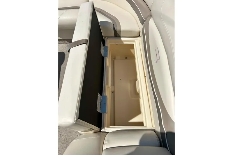 Slide: The Image of Open storage compartment on a 2006 Bennington 2250 RL boat with cushioned seating. - 25