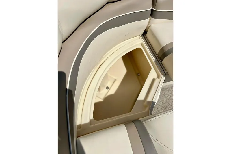 Slide: The Image of Storage compartment in 2006 Bennington 2250 RL boat with beige and gray seating. - 28