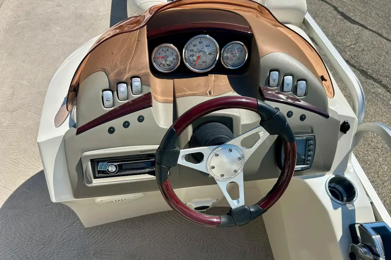 Slide: The Image of 2006 Bennington 2250 RL boat dashboard with steering wheel and gauges. - 29