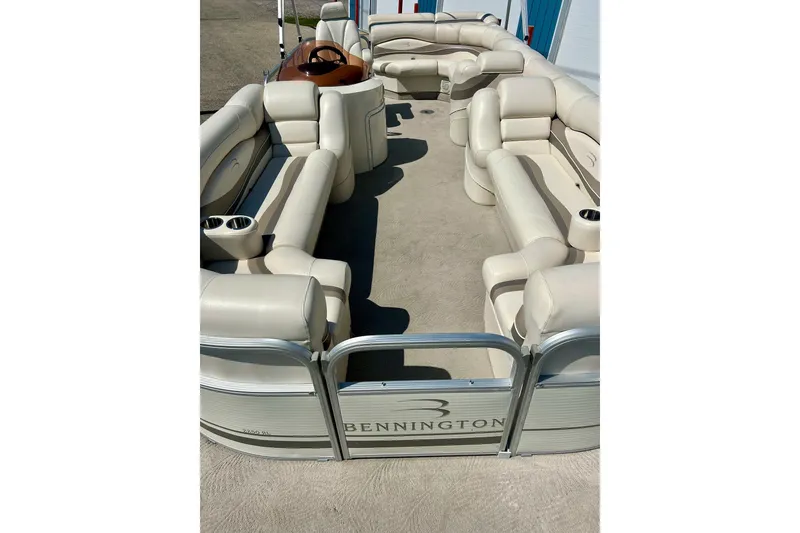 Slide: The Image of 2006 Bennington 2250 RL pontoon boat with spacious beige seating and modern design. - 6