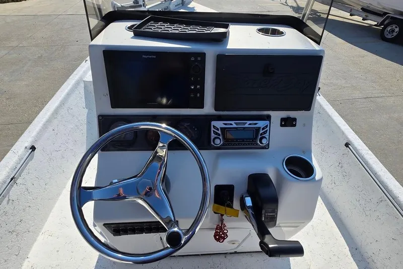 Slide: The Image of 2014 Blazer Bay 2170 boat console with steering wheel and navigation controls. - 11
