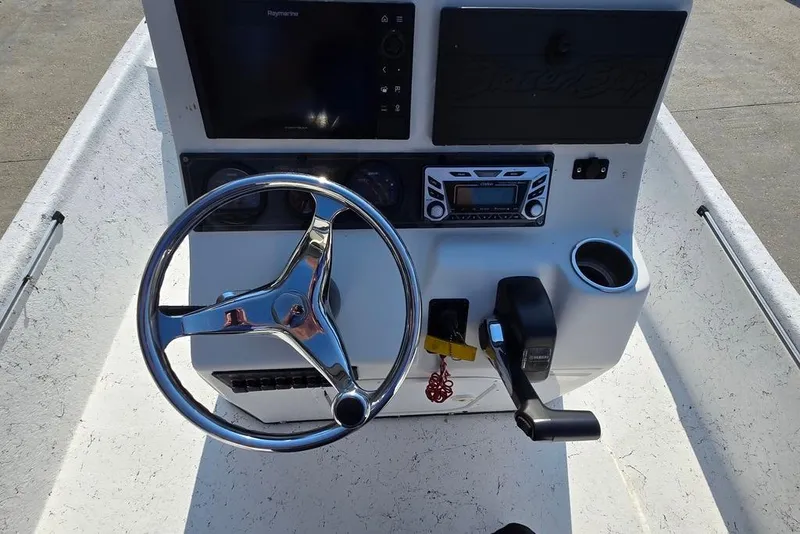 Slide: The Image of 2014 Blazer Bay 2170 boat console with steering wheel, controls, and navigation system. - 12