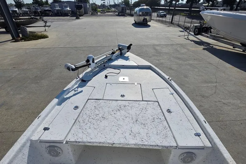 Slide: The Image of 2014 Blazer Bay 2170 boat deck with trolling motor in a marina setting. - 13