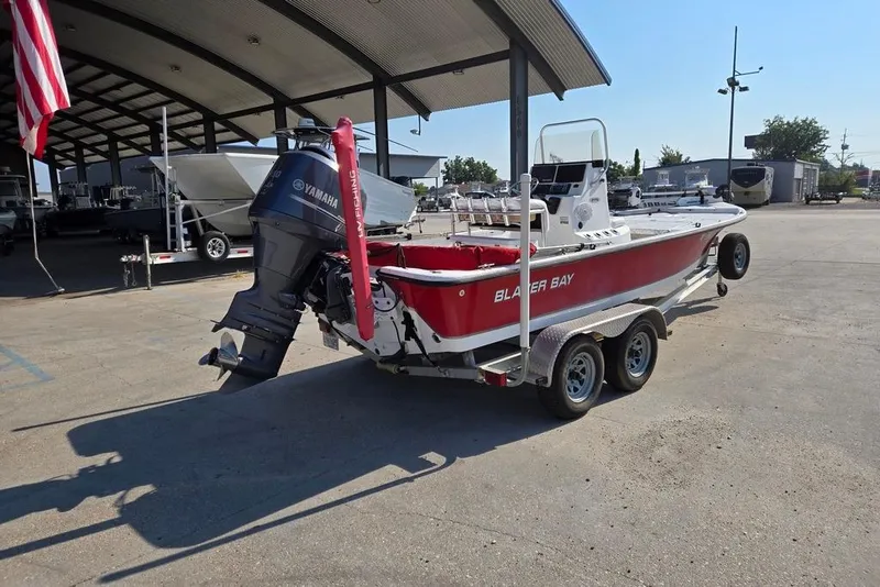 Slide: The Image of 2014 Blazer Bay 2170 boat with Yamaha motor on trailer in a marina. - 3