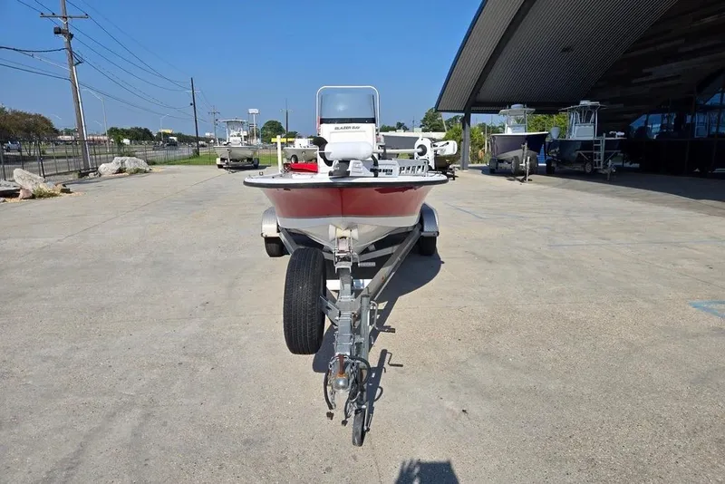 Slide: The Image of 2014 Blazer Bay 2170 boat on trailer in outdoor lot, clear sky background. - 7
