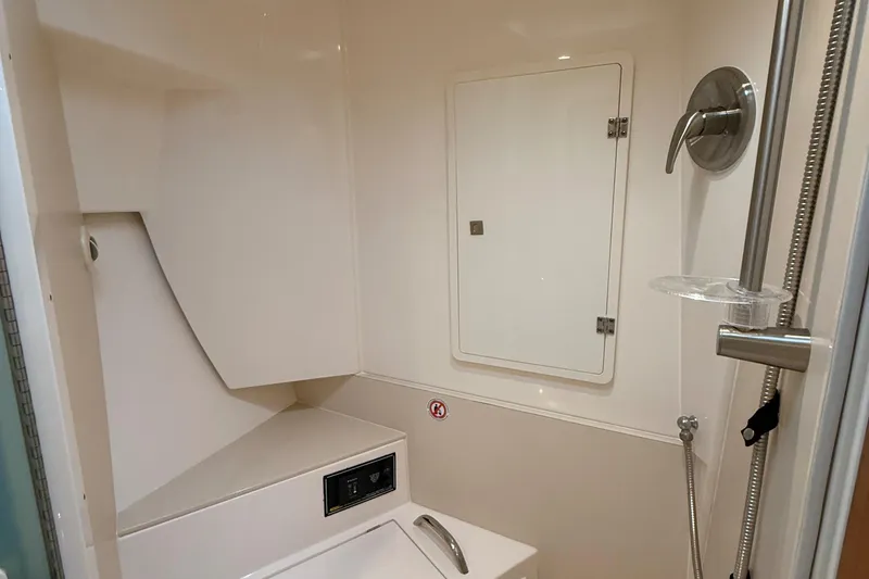 Slide: The Image of 2014 Pursuit SC 365i Sport Coupe bathroom with shower and storage compartment. - 11