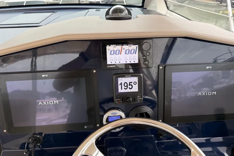 Slide: The Image of Helm of 2014 Pursuit SC 365i Sport Coupe with Axiom displays and navigation instruments. - 13