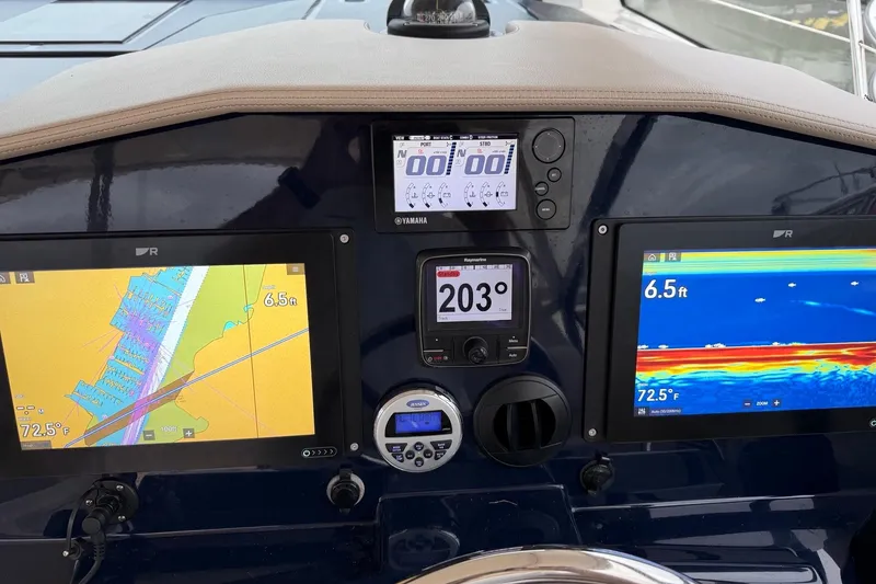 Slide: The Image of Dashboard of a 2014 Pursuit SC 365i Sport Coupe with navigation and sonar displays. - 14