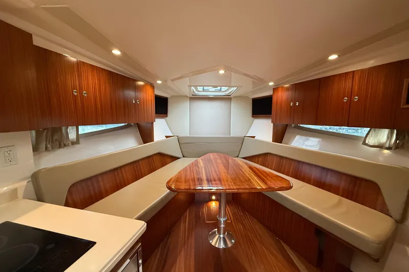 Slide: The Image of Luxurious interior of 2014 Pursuit SC 365i Sport Coupe with wood finishes and seating. - 16