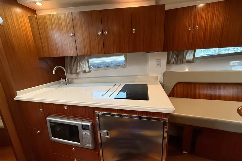 Slide: The Image of Luxurious 2014 Pursuit SC 365i Sport Coupe kitchen with wood cabinetry and modern appliances. - 17