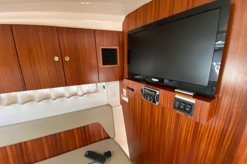 Slide: The Image of Interior of 2014 Pursuit SC 365i Sport Coupe with TV and wooden cabinetry. - 21