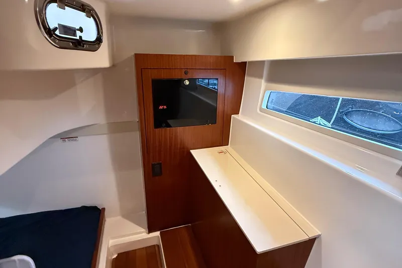 Slide: The Image of Interior cabin of 2014 Pursuit SC 365i Sport Coupe with wood accents and window. - 22