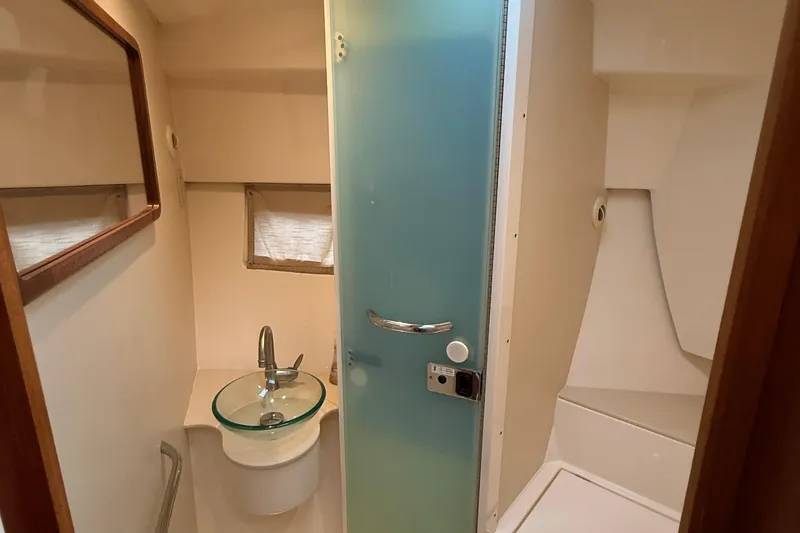 Slide: The Image of 2014 Pursuit SC 365i Sport Coupe bathroom with glass sink and frosted door. - 24