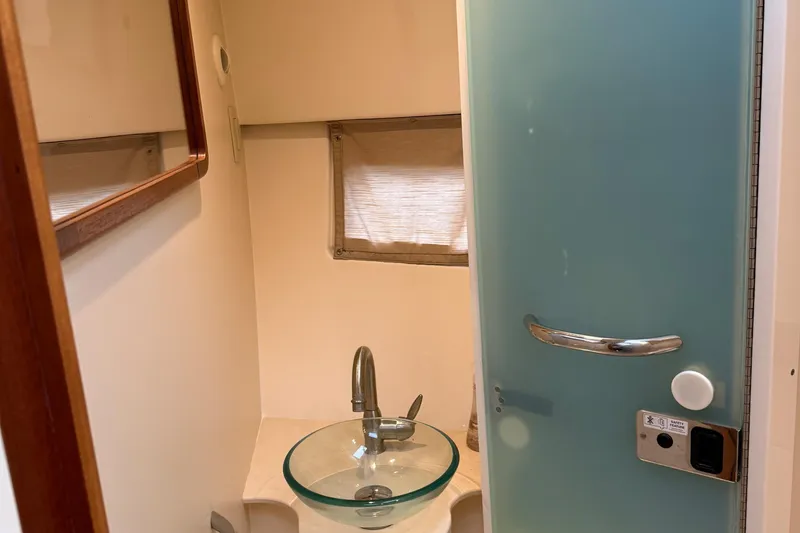 Slide: The Image of 2014 Pursuit SC 365i Sport Coupe bathroom with glass sink and frosted door. - 25