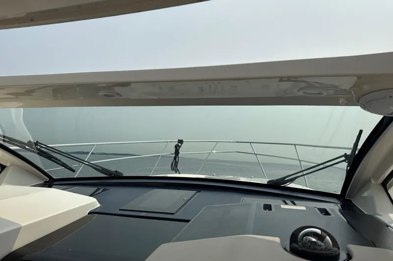 Slide: The Image of 2014 Pursuit SC 365i Sport Coupe helm view with ocean horizon. - 28
