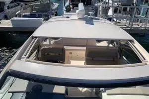 Slide: The Image of 2014 Pursuit SC 365i Sport Coupe docked, showcasing sleek design and spacious interior. - 7