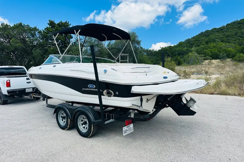 Slide: The Image of 2005 Chaparral 220 SSi boat on trailer, parked outdoors under a blue sky. - 10