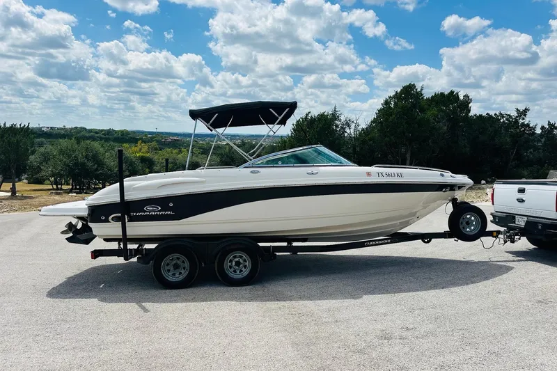 Slide: The Image of 2005 Chaparral 220 SSi boat on trailer, parked outdoors under a cloudy sky. - 11