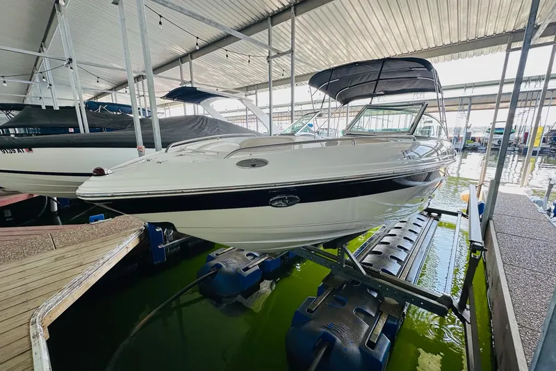 Slide: The Image of 2005 Chaparral 220 SSi boat on lift in covered marina. - 13