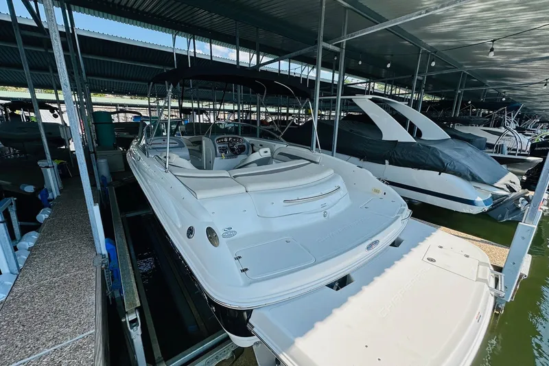 Slide: The Image of 2005 Chaparral 220 SSi boat docked in a covered marina. - 14
