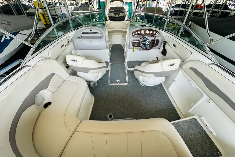 Slide: The Image of 2005 Chaparral 220 SSi boat interior with white seating and modern dashboard. - 16