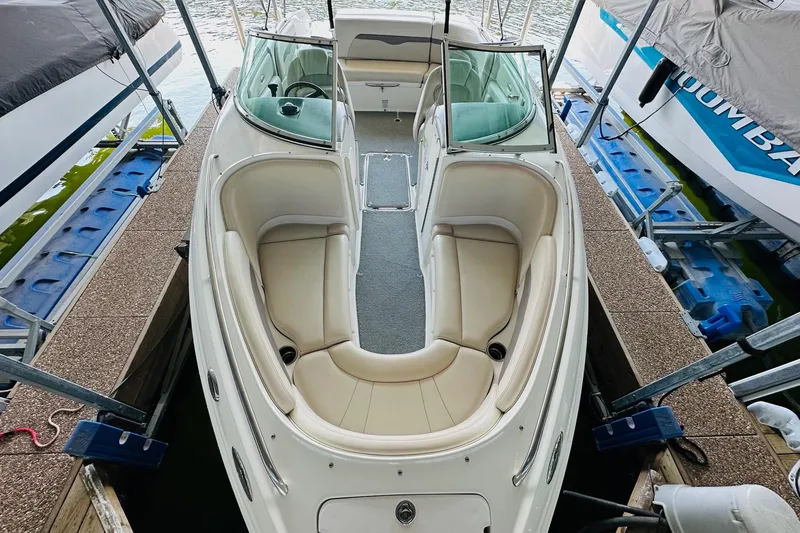 Slide: The Image of 2005 Chaparral 220 SSi boat docked, featuring spacious seating and sleek design. - 17