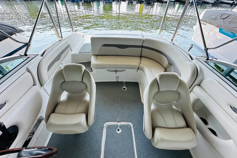 Slide: The Image of 2005 Chaparral 220 SSi boat interior with plush seating and lake view. - 18