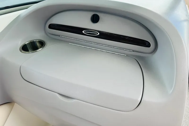 Slide: The Image of 2005 Chaparral 220 SSi boat dashboard with glove compartment and cup holder. - 20