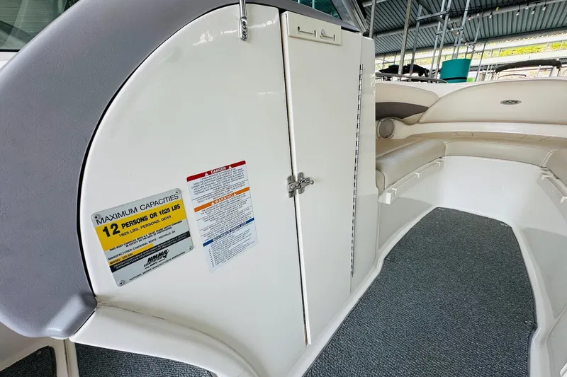 Slide: The Image of 2005 Chaparral 220 SSi boat interior, showing seating and capacity label for 12 persons. - 21
