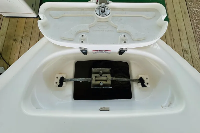 Slide: The Image of Open anchor compartment of 2005 Chaparral 220 SSi boat on wooden deck. - 22