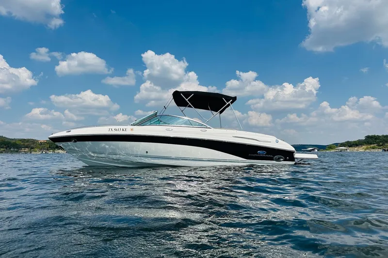 Slide: The Image of 2005 Chaparral 220 SSi boat on a sunny lake with blue sky and clouds. - 4
