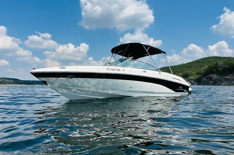 Slide: The Image of 2005 Chaparral 220 SSi boat on a lake under a clear blue sky. - 6