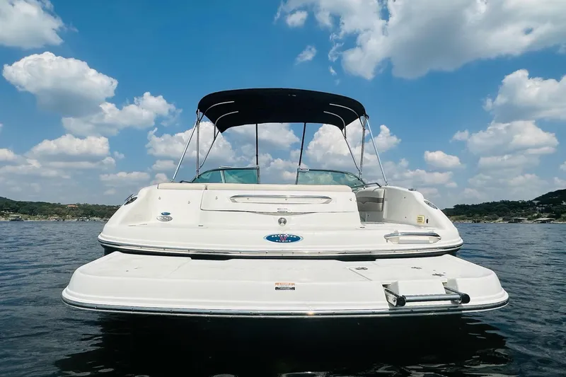 Slide: The Image of 2005 Chaparral 220 SSi boat on water under blue sky with clouds. - 7