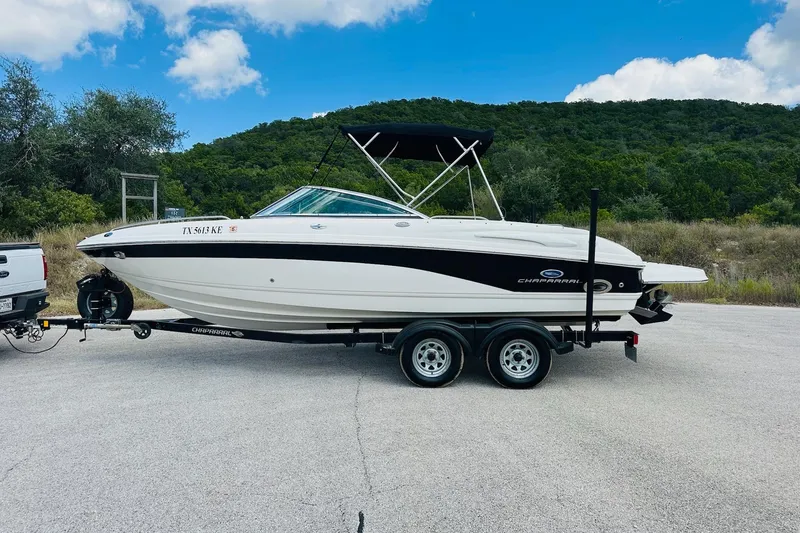 Slide: The Image of 2005 Chaparral 220 SSi boat on trailer, parked outdoors with scenic background. - 8
