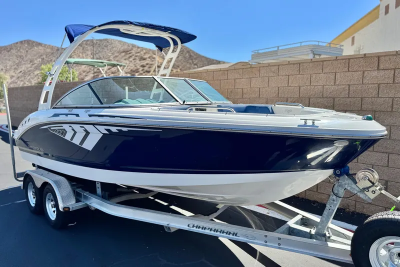 Slide: The Image of 2014 Chaparral 21 H2O Sport boat on trailer, parked outdoors. - 1